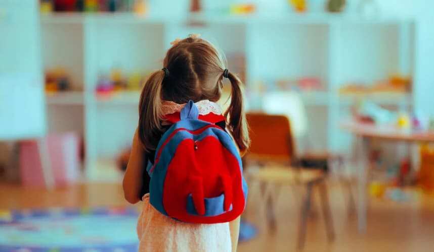 kreşe girmiş kız çocuğu sırtında çantasıyla etrafa bakıyor